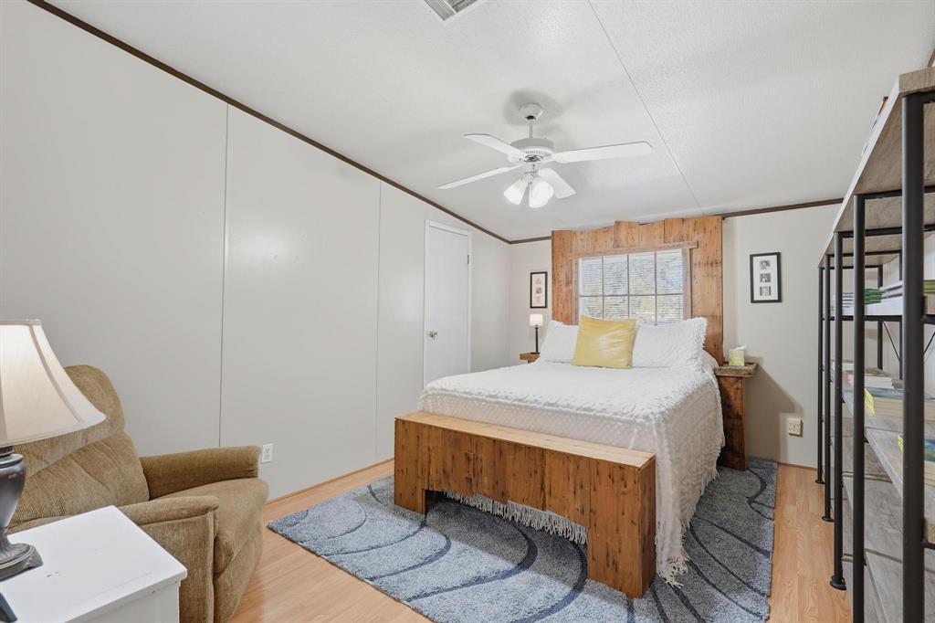 20082 County Road 304 Abilene, TX 79601 - Photo 23 of 36 a bedroom with a bed and a chandelier