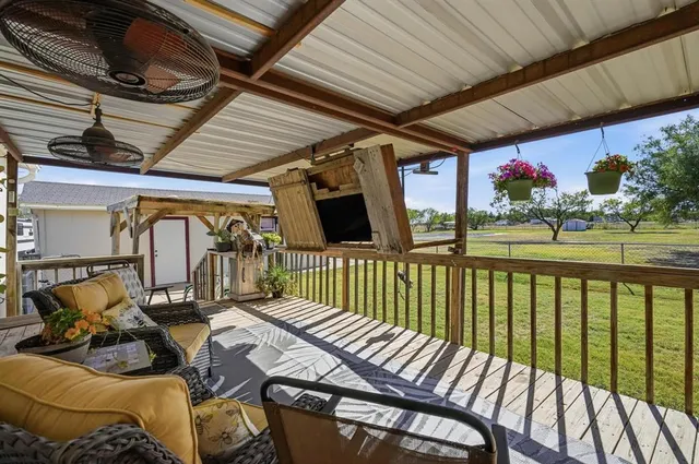 a view of balcony with furniture and garden