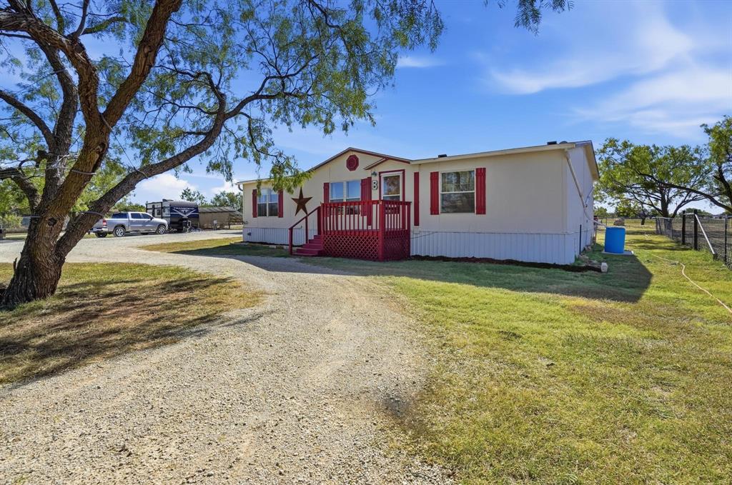 20082 County Road 304 Abilene, TX 79601 - Photo 4 of 36 a front view of house with yard and trees in the background