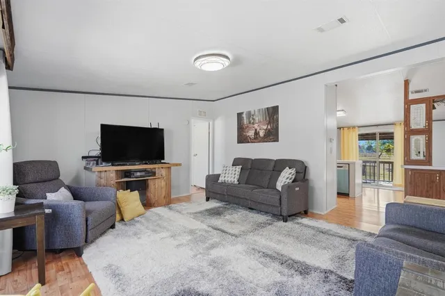 a spacious bedroom with a bed a couch and a window