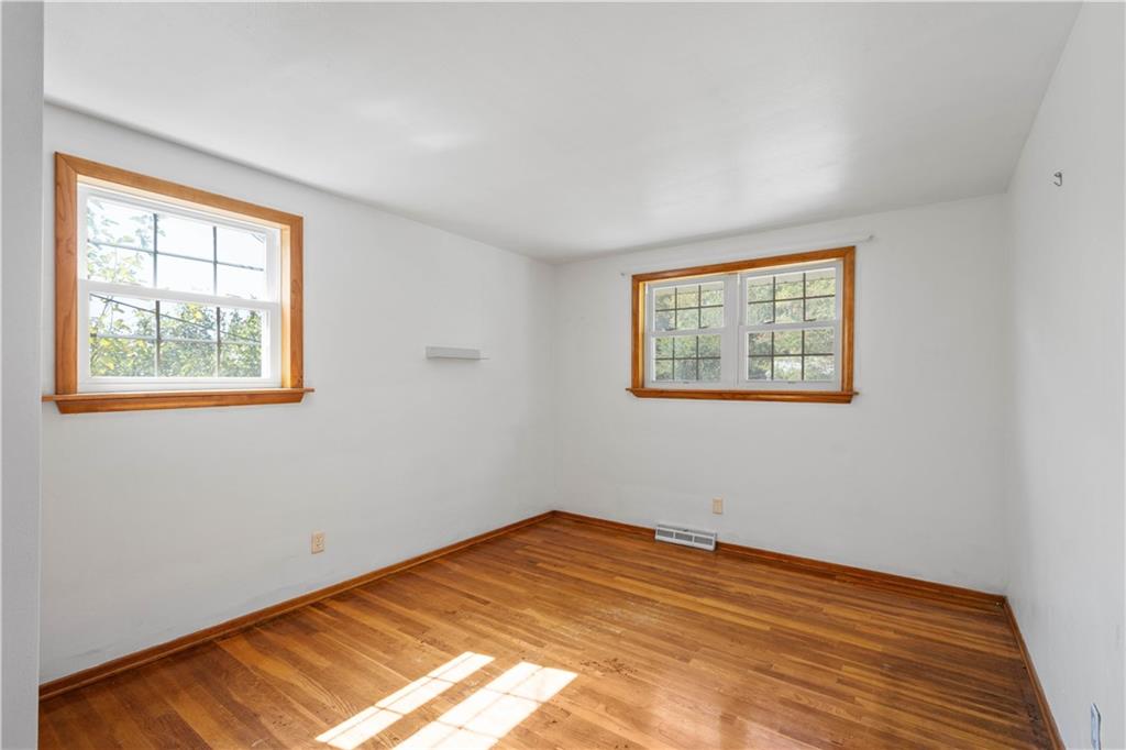 206 Hillendale Road Pittsburgh, PA 15237 - Photo 17 of 30 a view of an empty room with wooden floor and a window