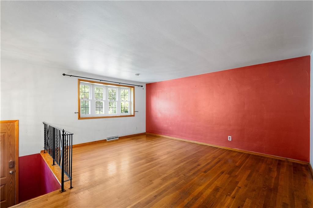 206 Hillendale Road Pittsburgh, PA 15237 - Photo 4 of 30 an empty room with wooden floor and windows