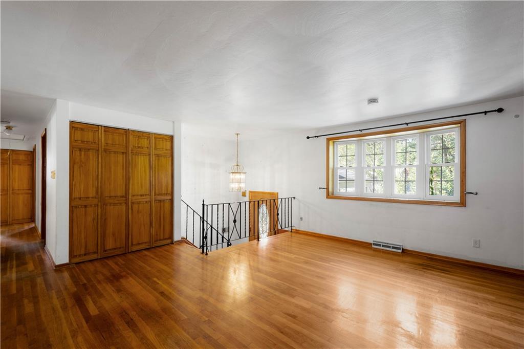 206 Hillendale Road Pittsburgh, PA 15237 - Photo 5 of 30 an empty room with wooden floor and windows