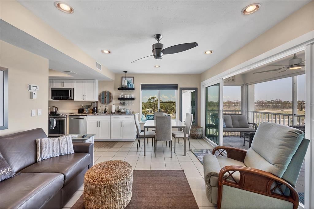 7070 Placida Road, Unit 1230 Placida, FL 33946 - Photo 15 of 60 a living room with furniture fireplace view and large windows