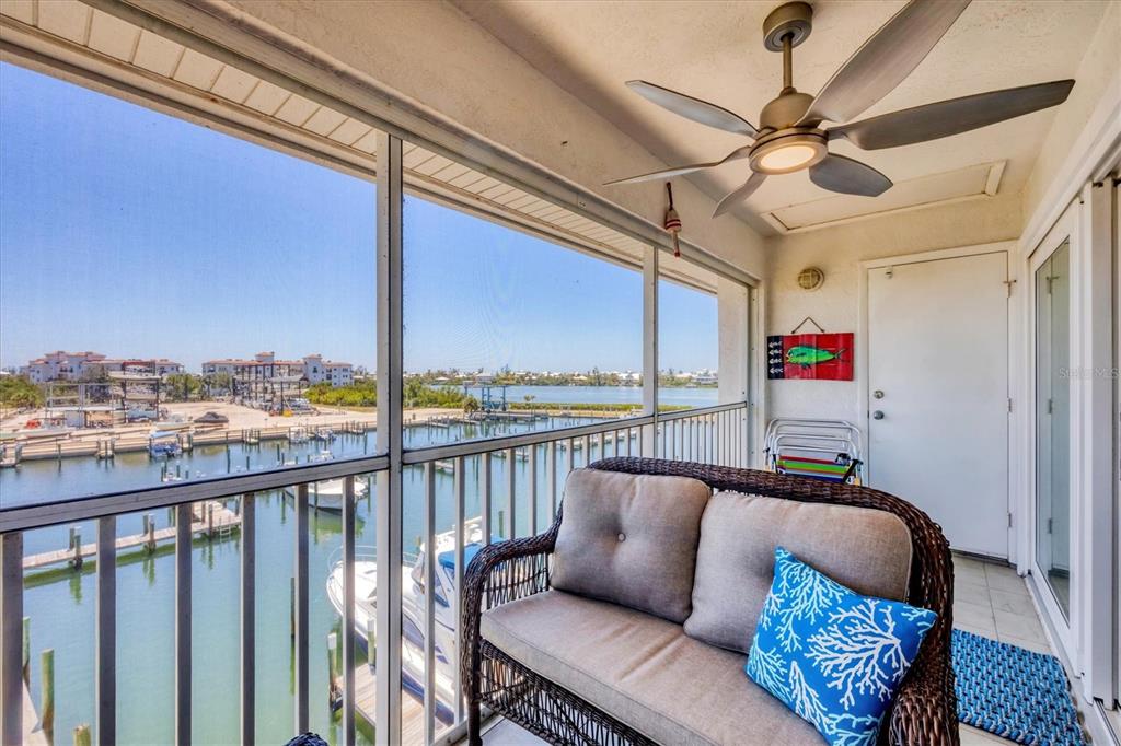 7070 Placida Road, Unit 1230 Placida, FL 33946 - Photo 42 of 60 a balcony with furniture and a ceiling fan