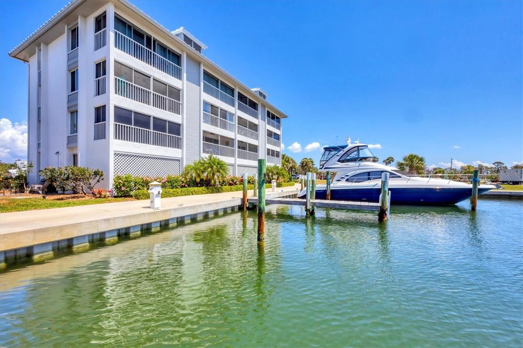 7070 Placida Road, Unit 1230 Placida, FL 33946 - Photo 45 of 60 a view of pool with lawn chairs and a large tree