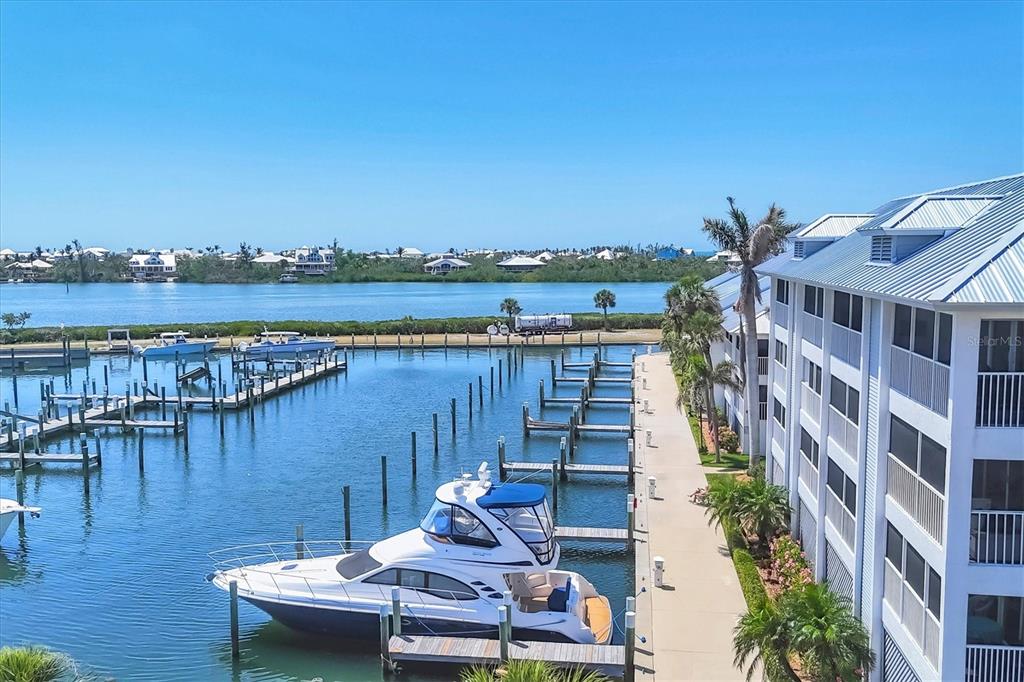 7070 Placida Road, Unit 1230 Placida, FL 33946 - Photo 48 of 60 a view of a lake with a table and chairs