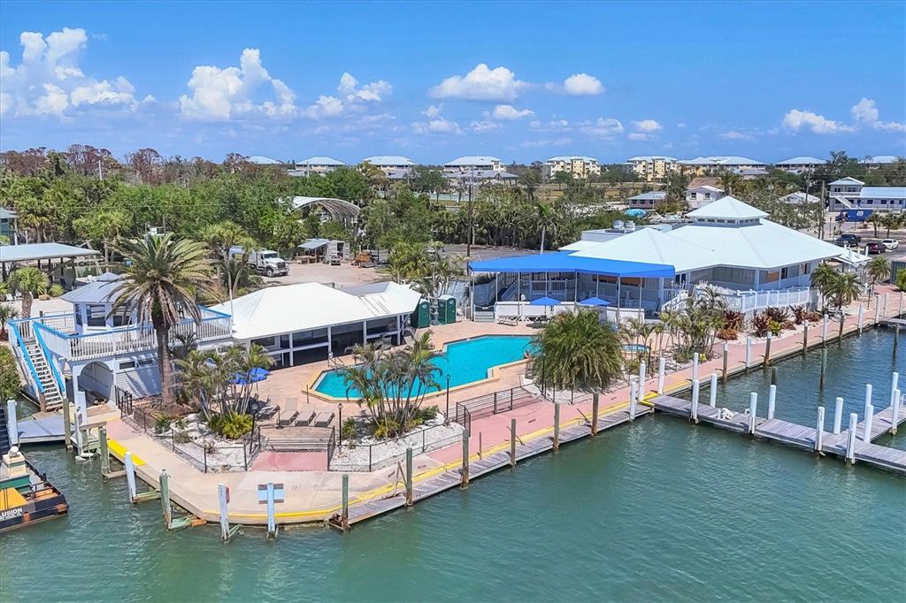 7070 Placida Road, Unit 1230 Placida, FL 33946 - Photo 59 of 60 a view of a city with lawn chairs and a large tree