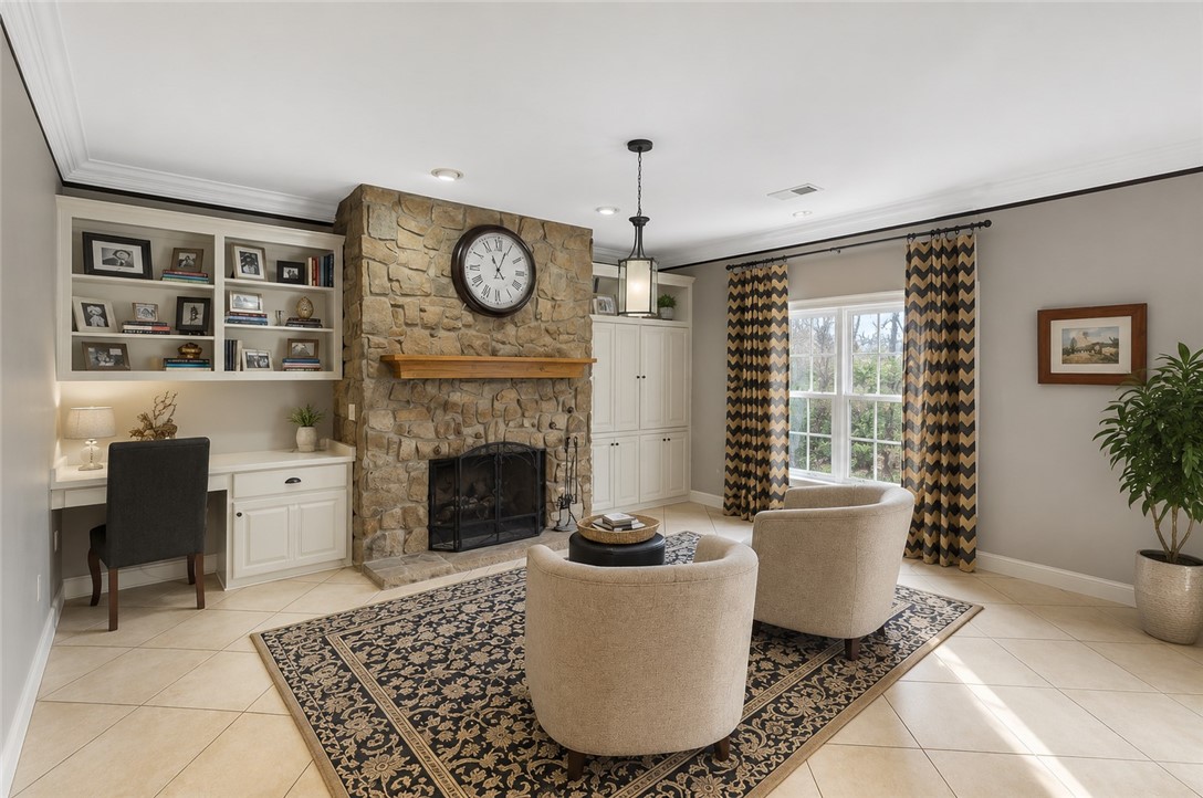 114 Augusta National Anderson, SC 29621 - Photo 46 of 47 A spacious sitting area features a stone fireplace, built-in cabinetry, and large windows with abundant natural light.