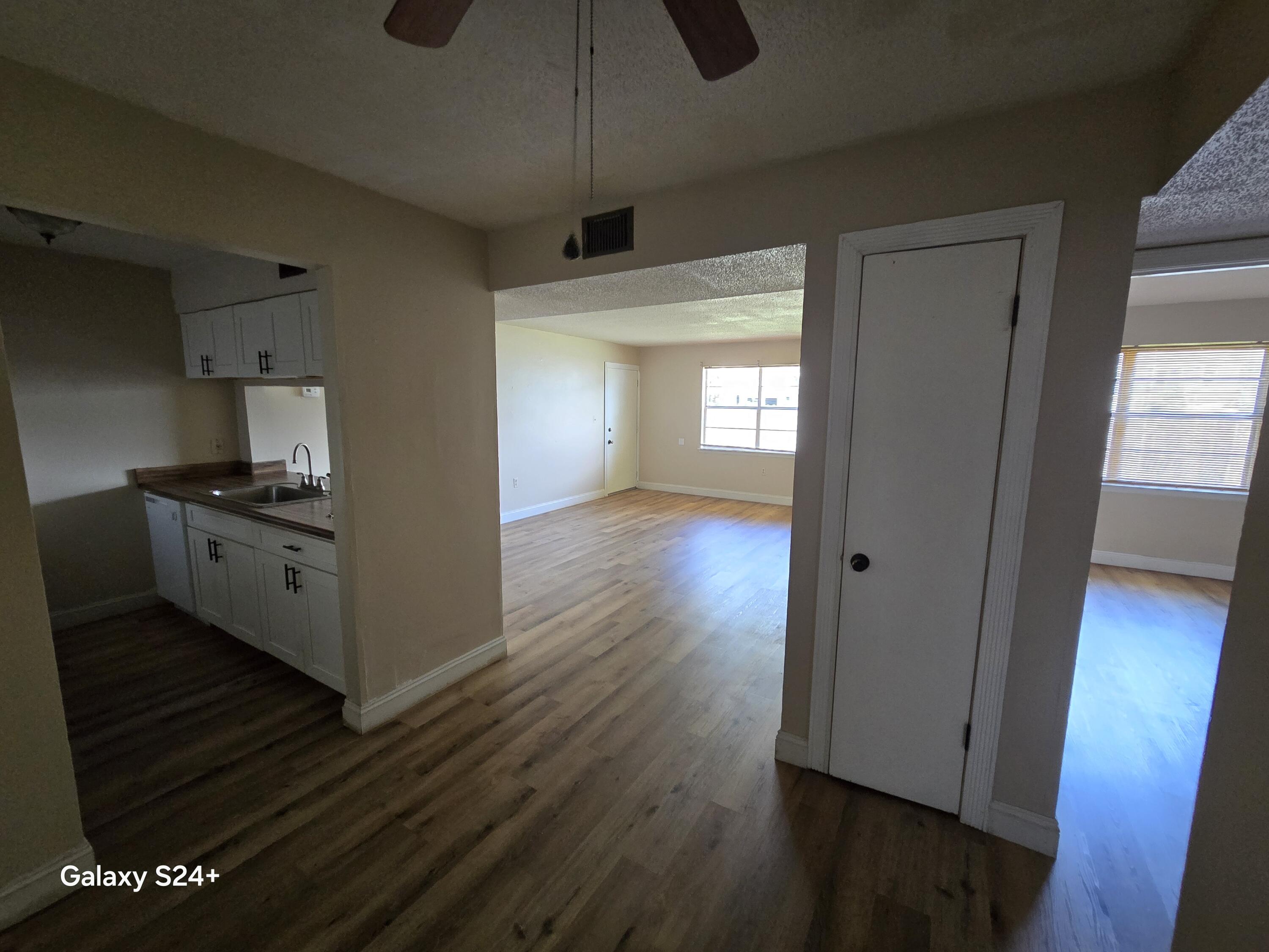 605 Colonial Drive, Unit 4 Fort Walton Beach, FL 32547 - Photo 11 of 13 a kitchen with stainless steel appliances a refrigerator and wooden floor