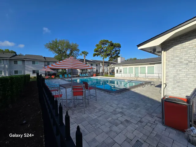 a view of a patio with table and chairs and potted plants