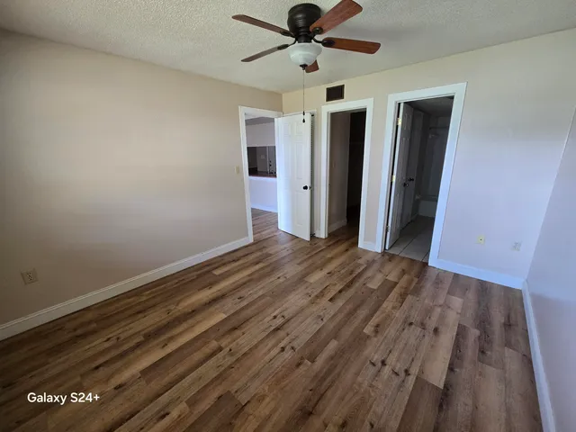 a view of an empty room and wooden floor