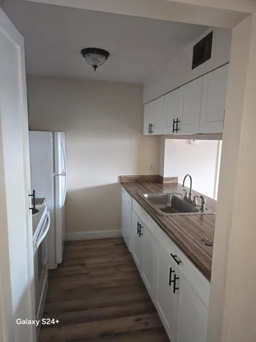a kitchen with granite countertop a stove and a refrigerator