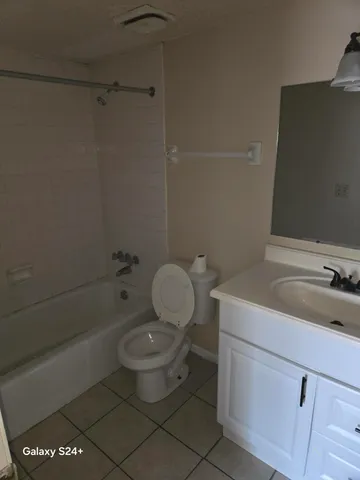 a bathroom with a toilet a sink and bathtub