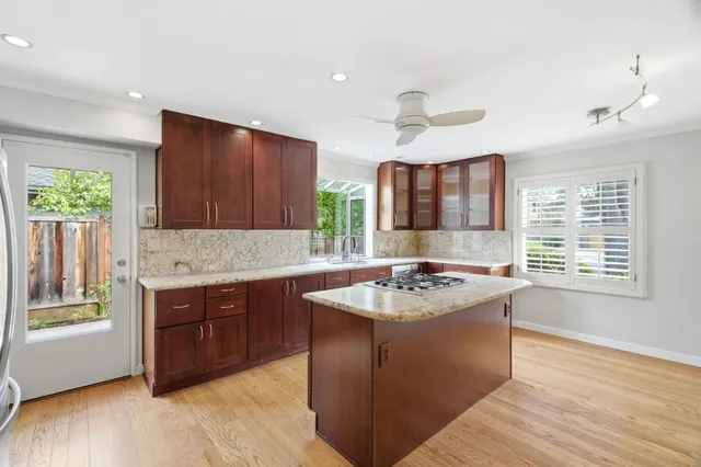 a kitchen with a stove sink and cabinets