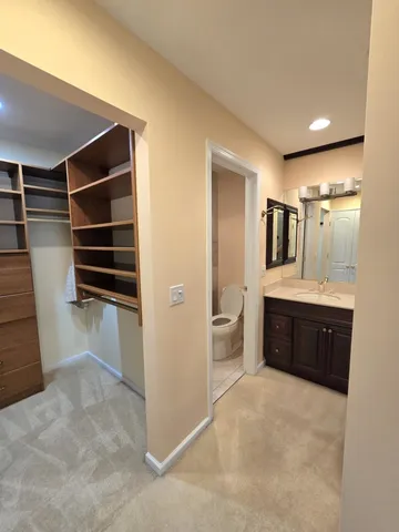 a bathroom with a double vanity sink a toilet and a bathtub