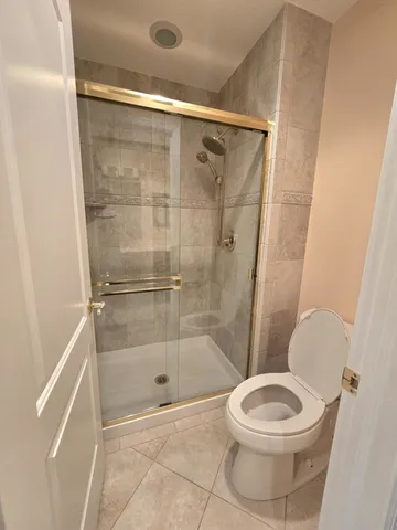 a bathroom with a toilet and a shower