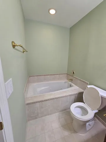 a bathroom with a toilet and bathtub