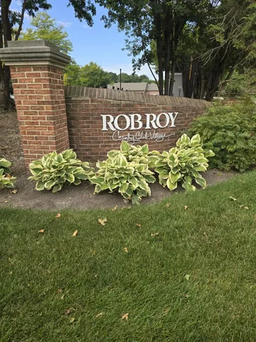 a sign that is sitting in front of flowers