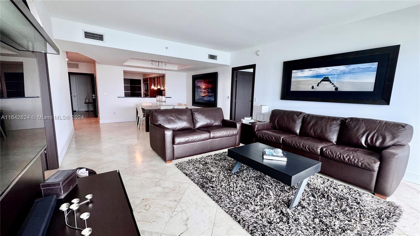 1331 Brickell Bay Drive, Unit 1109 Miami, FL 33131 - Photo 11 of 30 a living room with furniture and a rug