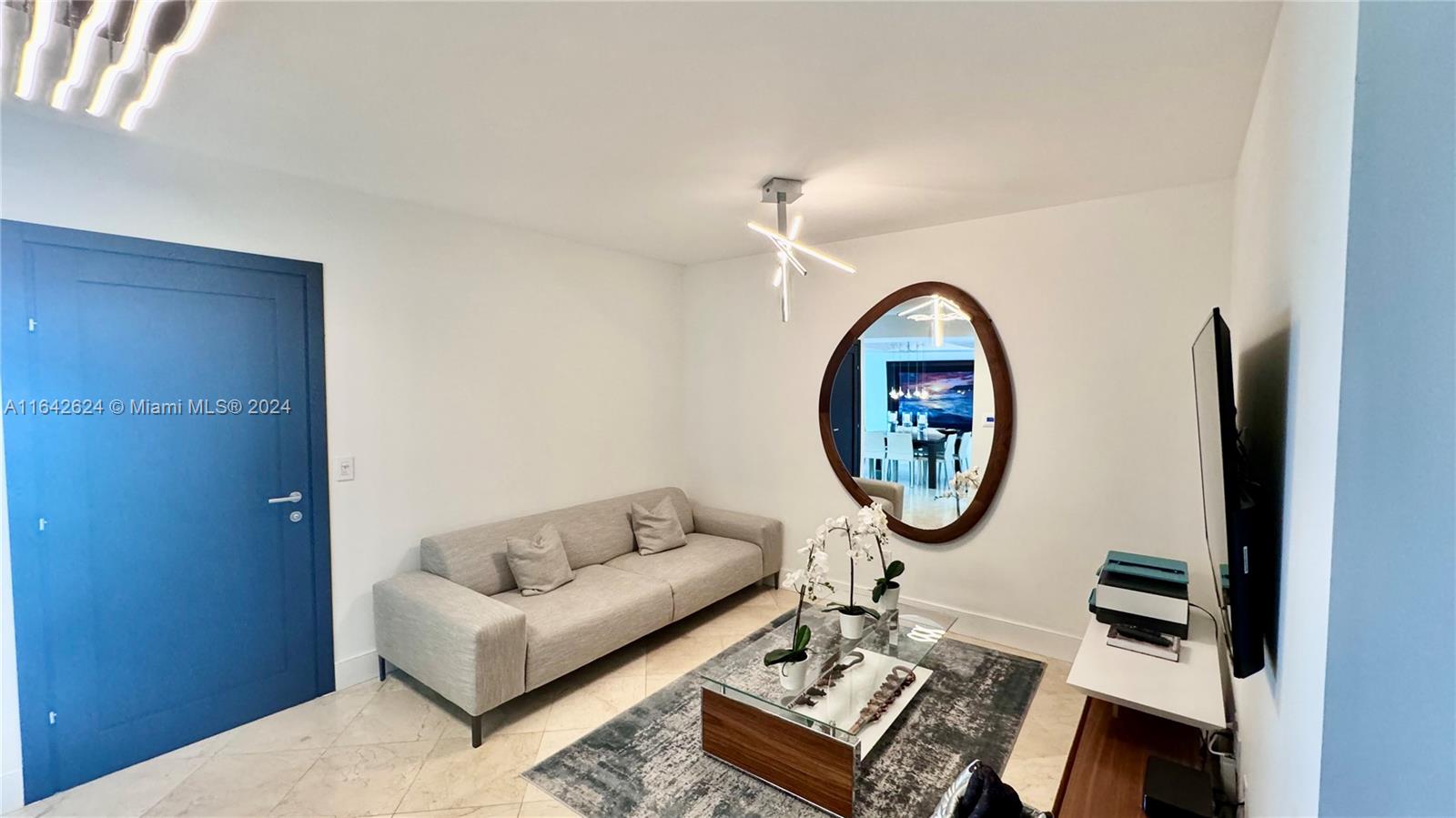 1331 Brickell Bay Drive, Unit 1109 Miami, FL 33131 - Photo 12 of 30 a living room with furniture a mirror and a table