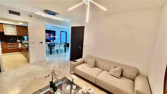 a living room with furniture and dining table