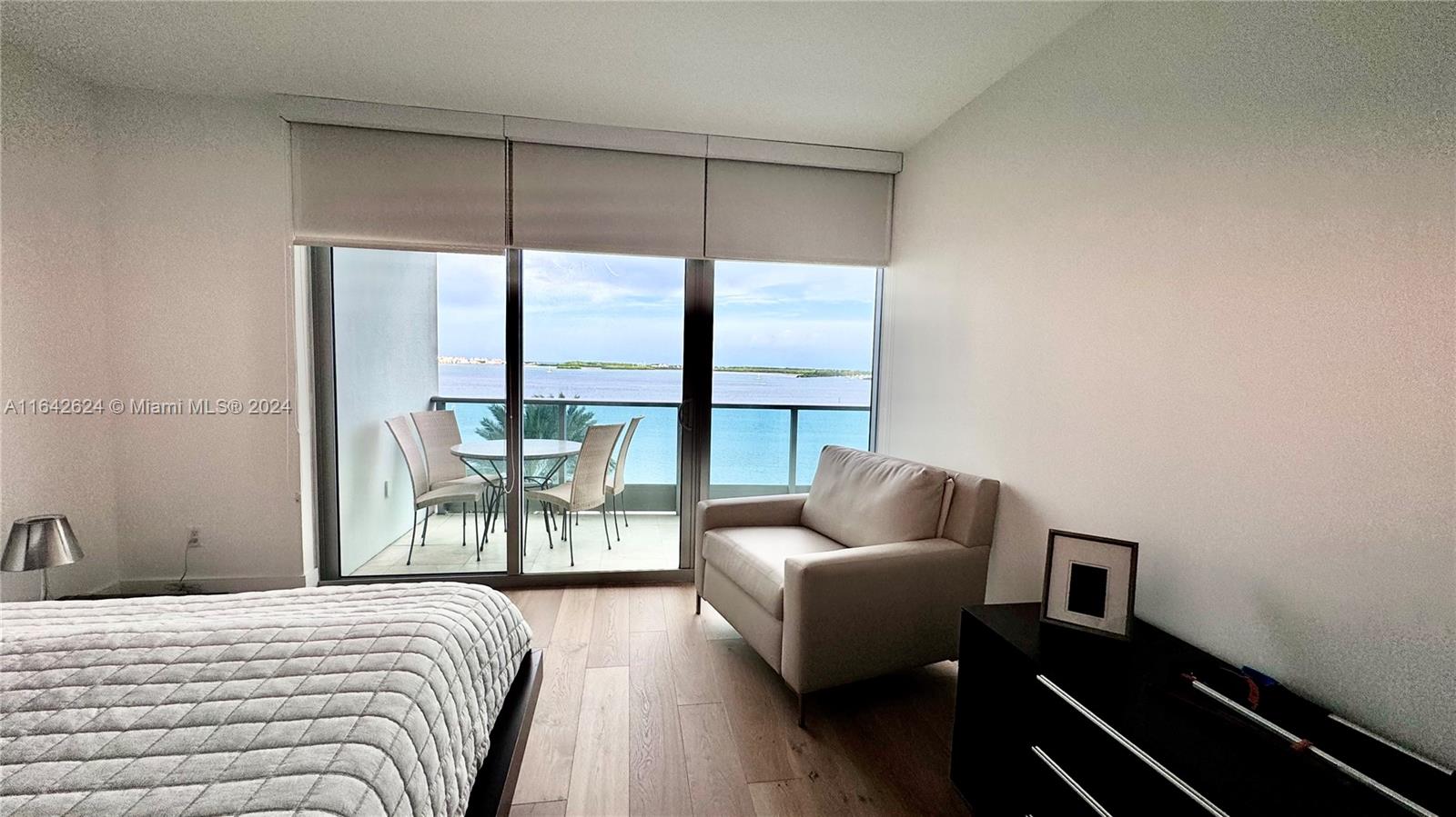 1331 Brickell Bay Drive, Unit 1109 Miami, FL 33131 - Photo 17 of 30 a bedroom with furniture and a large window
