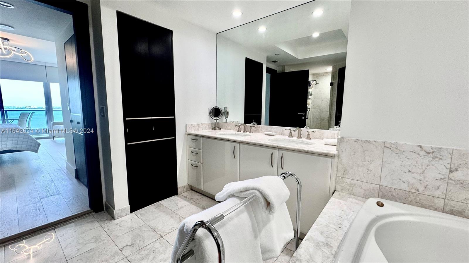 1331 Brickell Bay Drive, Unit 1109 Miami, FL 33131 - Photo 19 of 30 a bathroom with a sink and a mirror