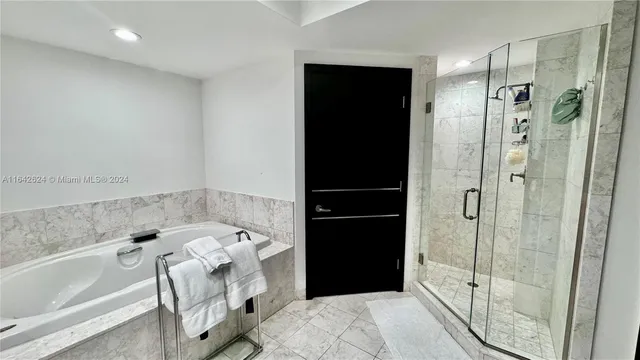 a bathroom with a bathtub and a shower