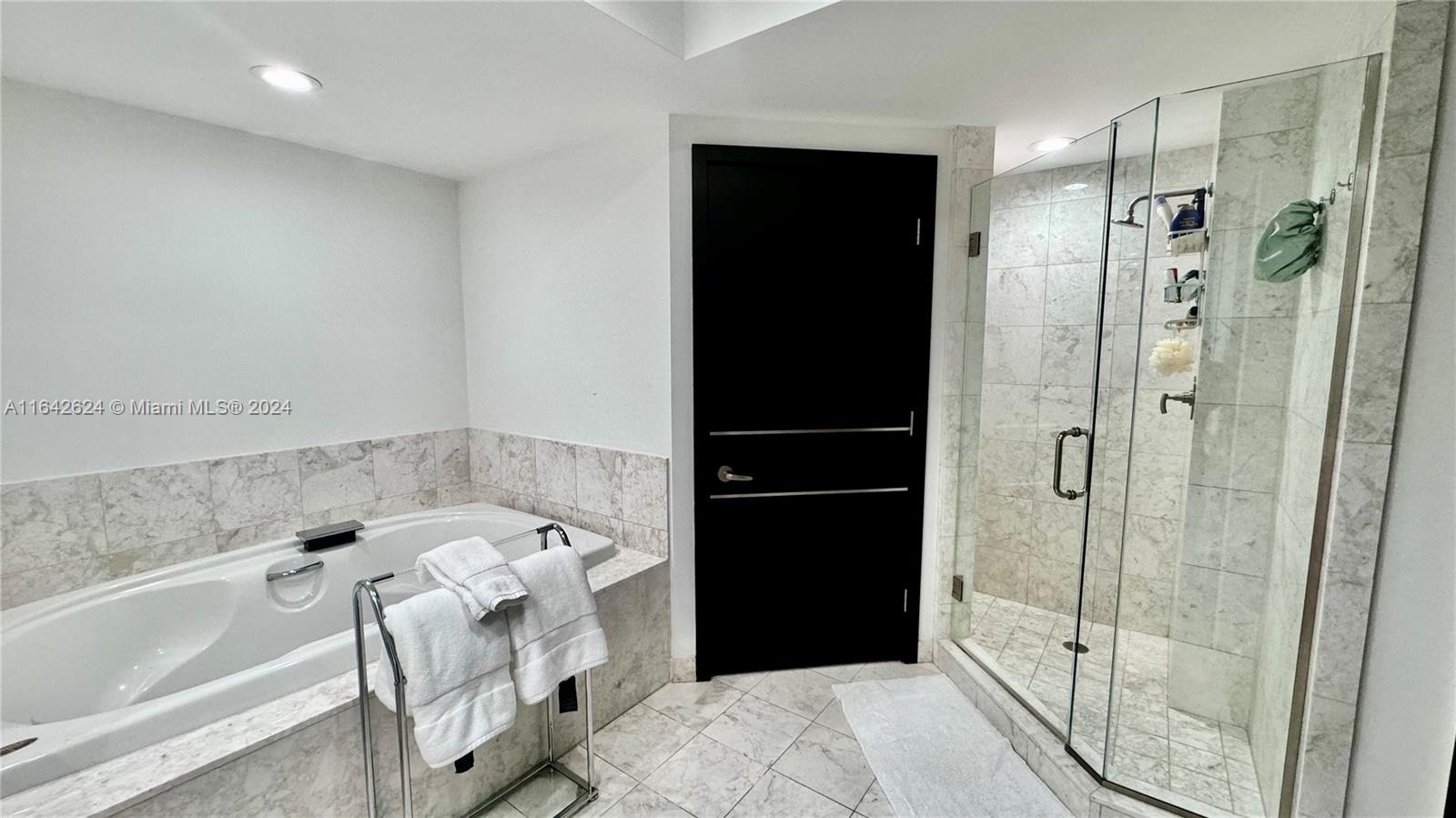 1331 Brickell Bay Drive, Unit 1109 Miami, FL 33131 - Photo 20 of 30 a bathroom with a bathtub and a shower