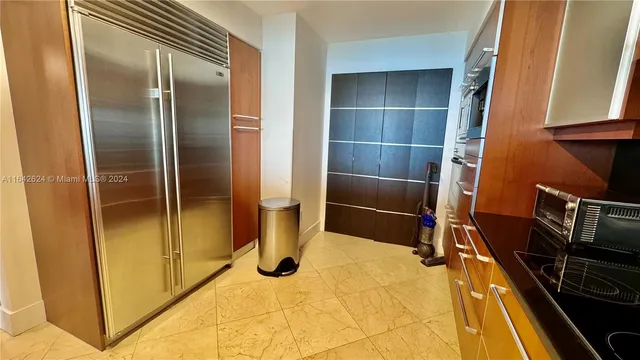 a kitchen with refrigerator and table