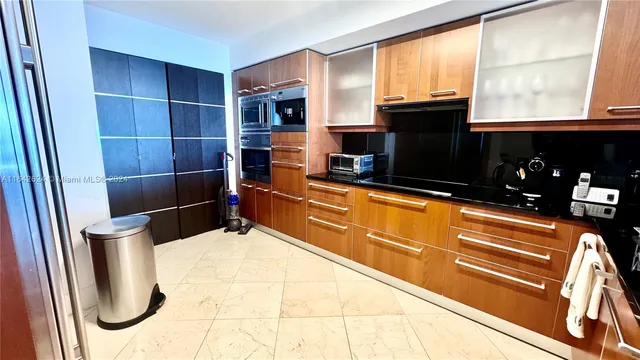 a kitchen with stainless steel appliances a refrigerator and a stove top oven
