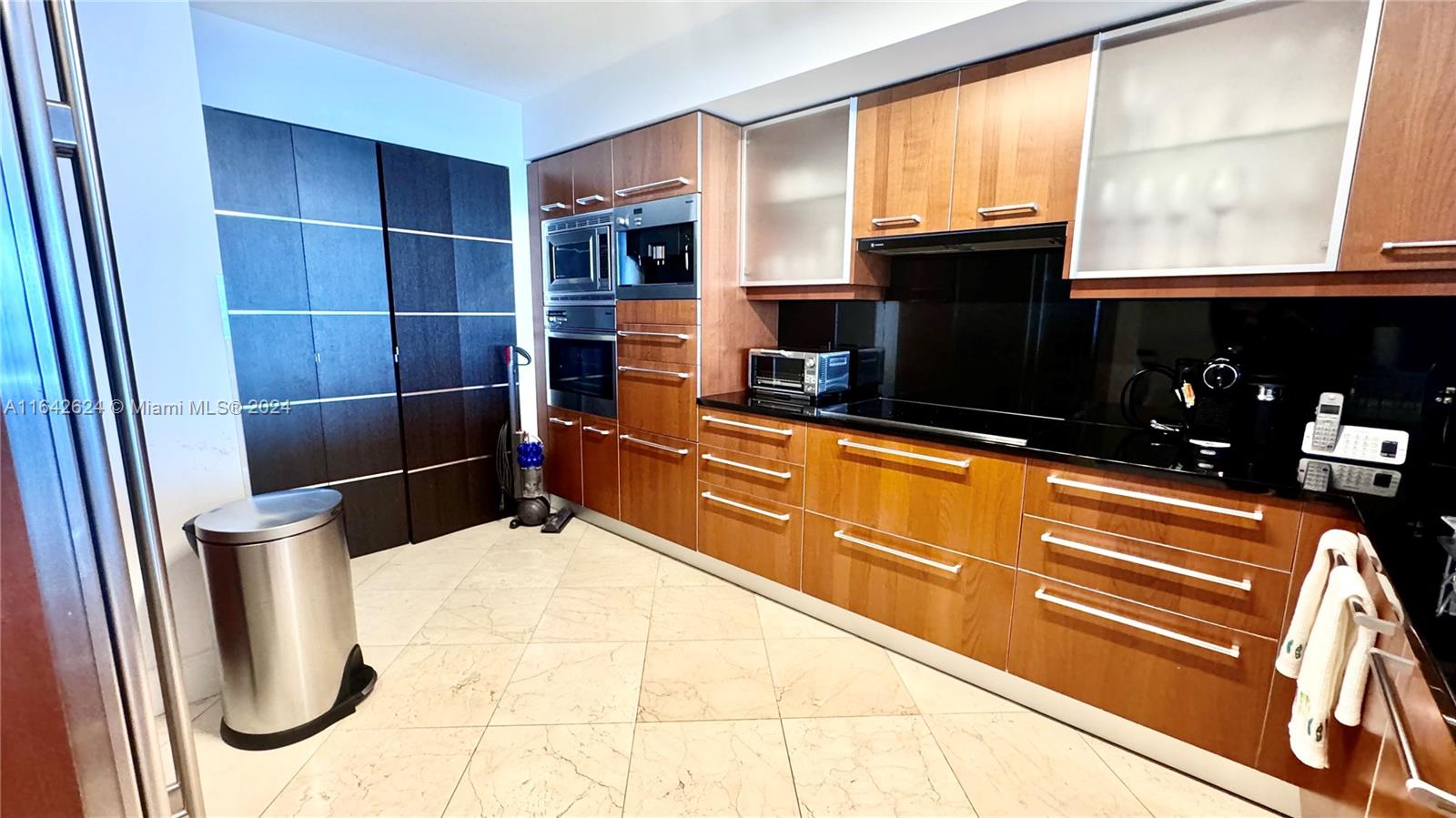 1331 Brickell Bay Drive, Unit 1109 Miami, FL 33131 - Photo 23 of 30 a kitchen with stainless steel appliances a refrigerator and a stove top oven
