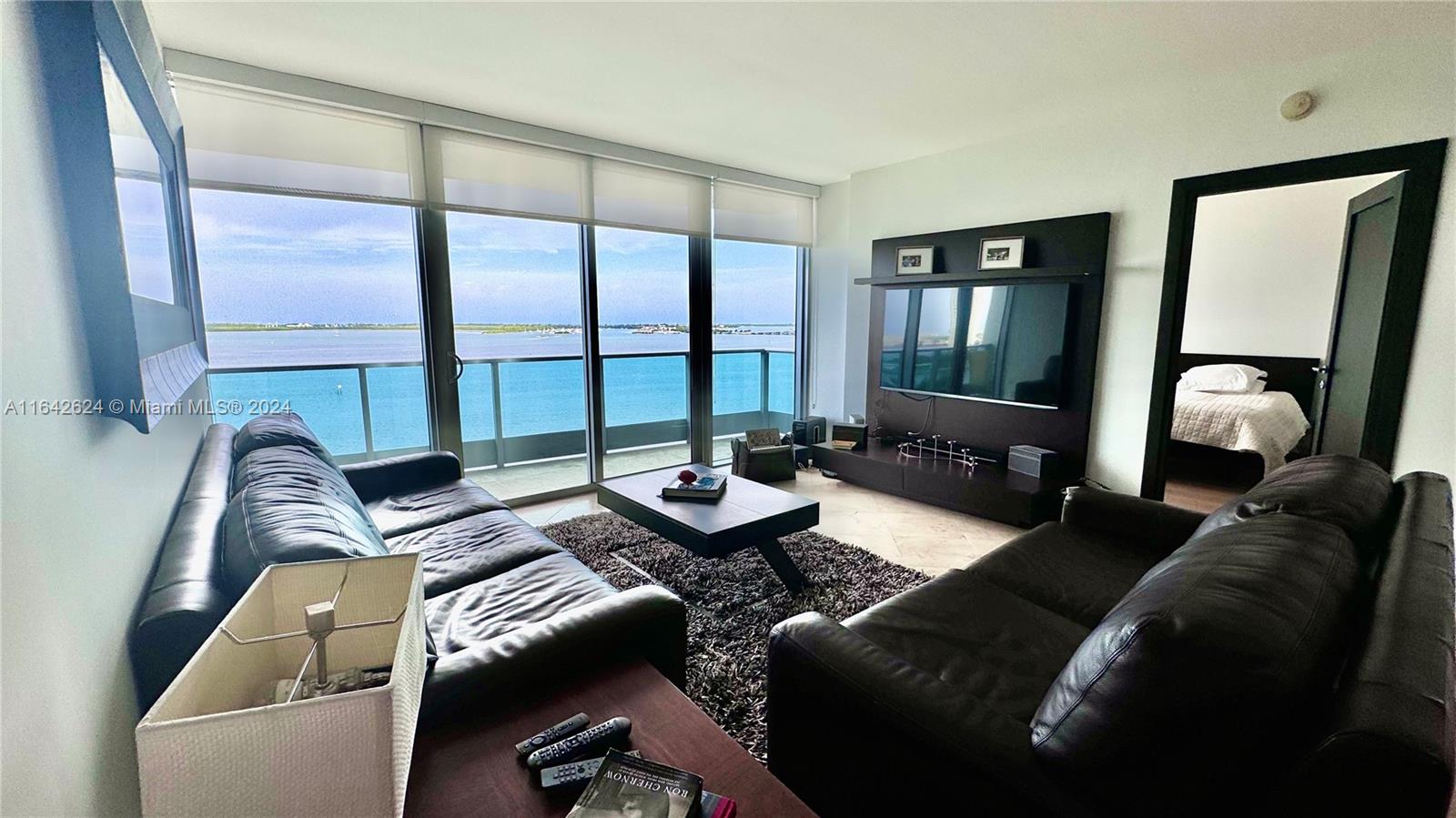 1331 Brickell Bay Drive, Unit 1109 Miami, FL 33131 - Photo 10 of 30 a living room with furniture and a large window