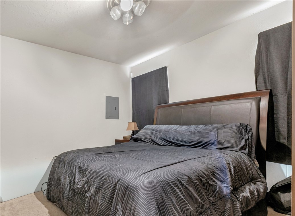 1003 West 17th Street Bryan, TX 77803 - Photo 5 of 6 Bedroom featuring carpet and electric panel