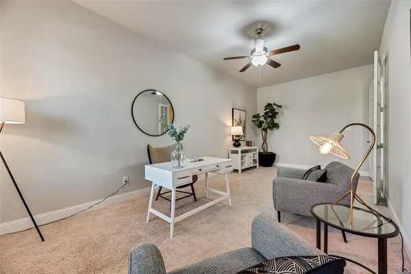 a living room with furniture a rug and white walls