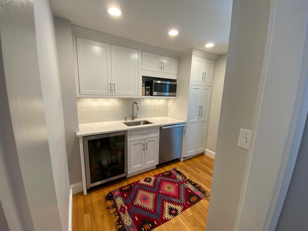 11 Arnold Road Wellesley, MA 02481 - Photo 16 of 33 a kitchen with stainless steel appliances granite countertop a stove a sink and a microwave