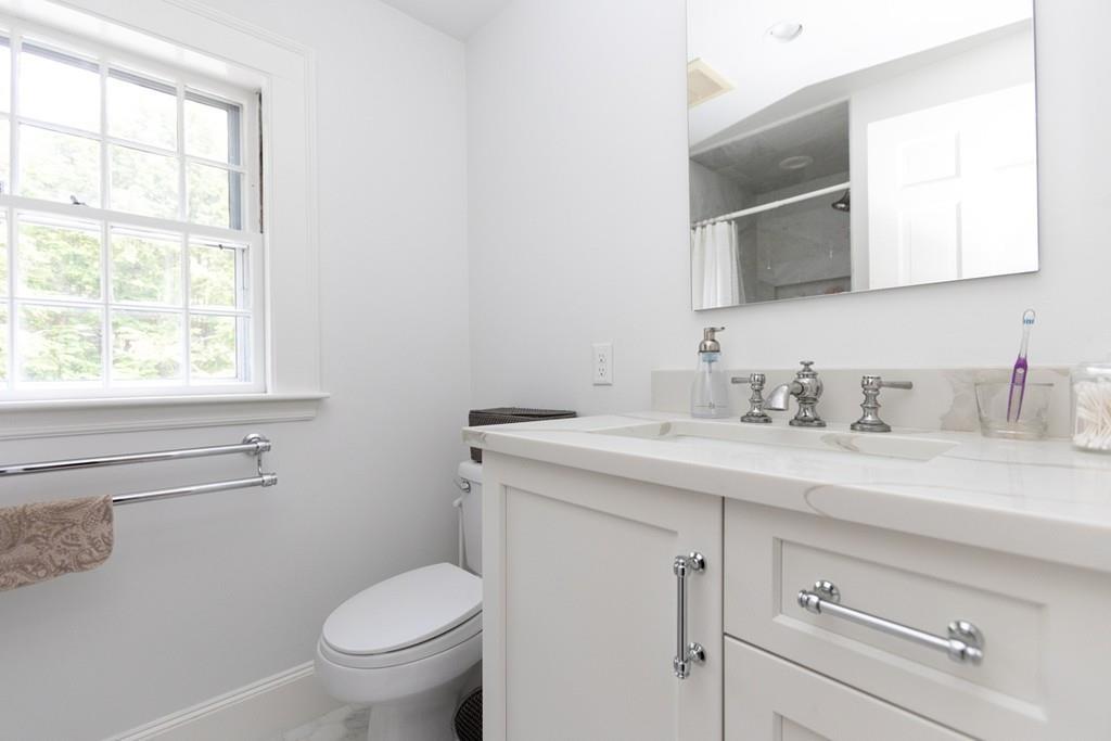 11 Arnold Road Wellesley, MA 02481 - Photo 21 of 33 a bathroom with a granite countertop toilet sink and mirror