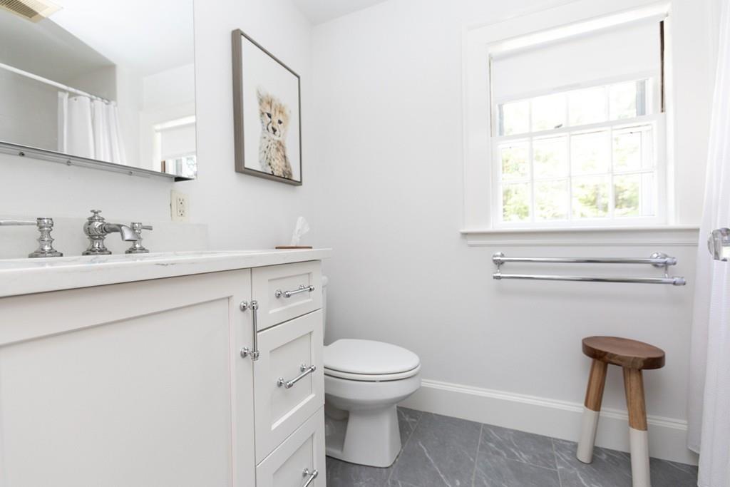 11 Arnold Road Wellesley, MA 02481 - Photo 26 of 33 a bathroom with a toilet sink and mirror