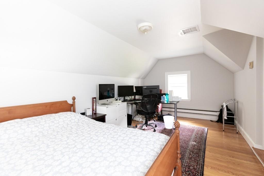 11 Arnold Road Wellesley, MA 02481 - Photo 27 of 33 a bedroom with furniture and a wooden floor