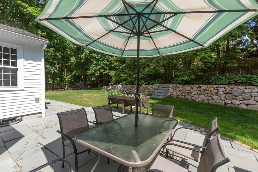 11 Arnold Road Wellesley, MA 02481 - Photo 28 of 33 a patio with a yard table and chairs