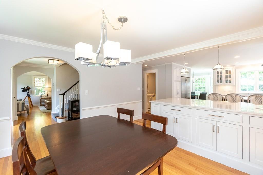 11 Arnold Road Wellesley, MA 02481 - Photo 8 of 33 a dining room with wooden floor a chandelier a wooden table and chairs