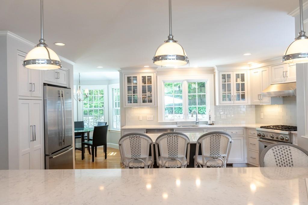 11 Arnold Road Wellesley, MA 02481 - Photo 10 of 33 a kitchen with stainless steel appliances granite countertop a stove a sink a refrigerator a center island a stove and a window