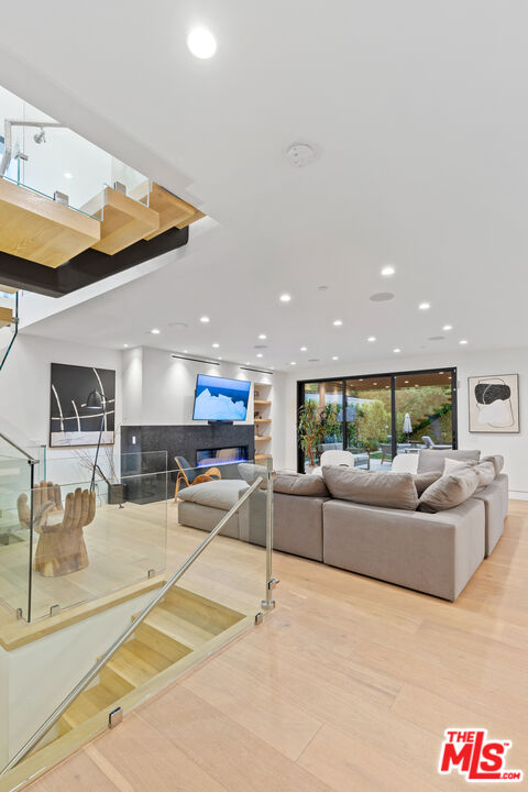 731 North Curson Avenue Los Angeles, CA 90046 - Photo 13 of 75 a living room with furniture and a flat screen tv