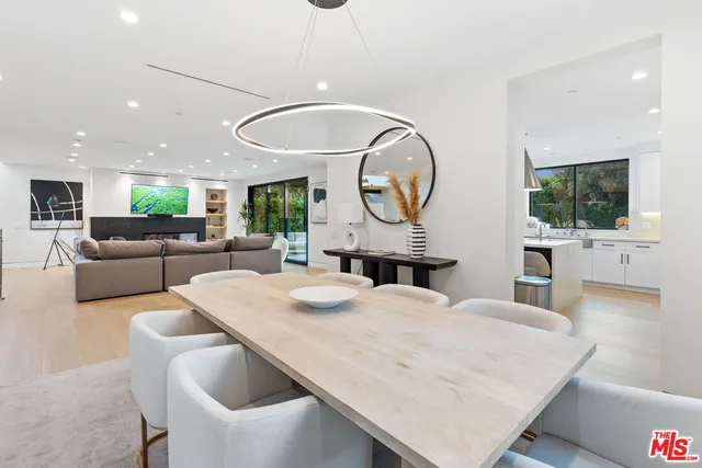 a kitchen with stainless steel appliances granite countertop a sink a stove and a refrigerator