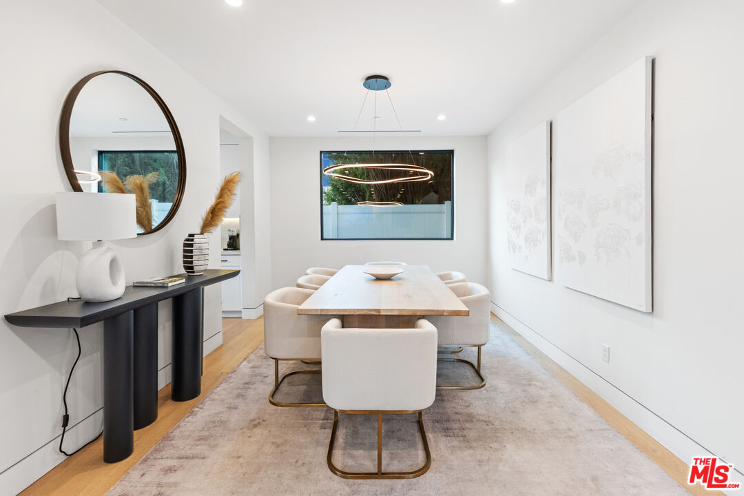 731 North Curson Avenue Los Angeles, CA 90046 - Photo 19 of 75 a living room with furniture a mirror and a wooden floor