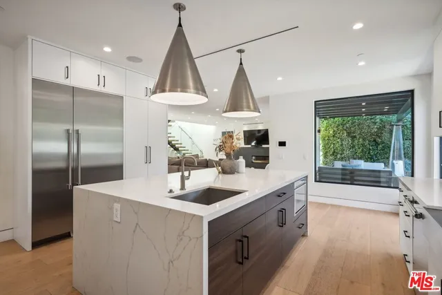 a spacious bathroom with a sink and a mirror