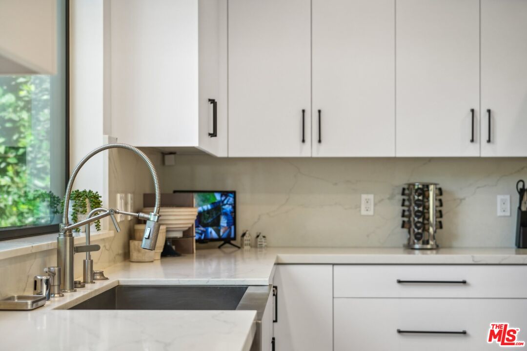 731 North Curson Avenue Los Angeles, CA 90046 - Photo 27 of 75 a kitchen with a sink and white cabinets