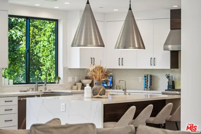 a large bed sitting in a bedroom next to a window
