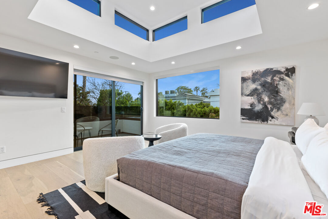 731 North Curson Avenue Los Angeles, CA 90046 - Photo 32 of 75 a living room with furniture large window and a flat screen tv